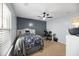 Stylish bedroom with light blue walls, ceiling fan, and cozy office workspace at 3506 Galaxy Rd, Ladson, SC 29456