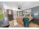 Comfortable bedroom with large window, ceiling fan, and stylish earth tone bedding at 3506 Galaxy Rd, Ladson, SC 29456