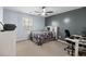 Stylish bedroom with light blue walls, ceiling fan, and cozy office workspace at 3506 Galaxy Rd, Ladson, SC 29456