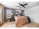Comfortable bedroom with large window, ceiling fan, and stylish earth tone bedding at 3506 Galaxy Rd, Ladson, SC 29456