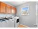 Bright laundry room featuring upper cabinets and a window for natural light at 3506 Galaxy Rd, Ladson, SC 29456