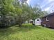 A large yard with a mix of grass and ground cover, mature shade trees, and a house at 36 Guerry Cir, Goose Creek, SC 29445