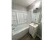 Bright bathroom features a tub and shower combination with built-in shelving and a vanity with updated fixtures at 36 Guerry Cir, Goose Creek, SC 29445