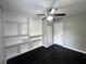 A bedroom with a ceiling fan, built in shelves, dark wood floors, and a closet at 36 Guerry Cir, Goose Creek, SC 29445