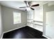 A bedroom with a ceiling fan, dark wood floors, built in shelves, and a window at 36 Guerry Cir, Goose Creek, SC 29445