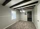 A dining room with dark wood beams, neutral walls, carpet flooring, and a chandelier at 36 Guerry Cir, Goose Creek, SC 29445