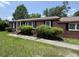 Charming single-story brick home featuring well-maintained landscaping, a covered porch, and classic black shutters at 36 Guerry Cir, Goose Creek, SC 29445