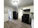 A kitchen with white cabinets, a black refrigerator, and a black stove at 36 Guerry Cir, Goose Creek, SC 29445
