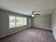 Living room featuring plush carpet flooring, a ceiling fan with lighting, neutral paint, and natural light at 36 Guerry Cir, Goose Creek, SC 29445