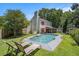 Inviting backyard features a sparkling pool, lounge chairs and screened in porch; perfect for relaxation and entertaining at 3813 Battleview Ct, North Charleston, SC 29420