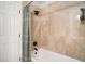 Classic bathroom with beige tile walls, white tub, a shower curtain, and updated fixtures at 3813 Battleview Ct, North Charleston, SC 29420