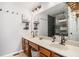 Bright bathroom featuring a double sink vanity, large mirror, and a glass-enclosed shower with modern tile at 3813 Battleview Ct, North Charleston, SC 29420