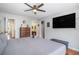 Spacious bedroom featuring a large bed, flat screen TV, and adjoining bathroom at 3813 Battleview Ct, North Charleston, SC 29420
