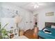 A bright bedroom features hardwood floors, a neutral color palette, and natural light through a double door at 3813 Battleview Ct, North Charleston, SC 29420