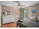 Comfortable bedroom featuring hardwood floors, a ceiling fan, neutral walls, and a large dresser with mirror at 3813 Battleview Ct, North Charleston, SC 29420