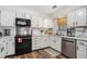 Bright kitchen with white cabinets, stainless steel appliances, and wood floors at 3813 Battleview Ct, North Charleston, SC 29420