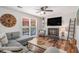 Cozy living room with fireplace, sectional sofa, and view of the pool at 3813 Battleview Ct, North Charleston, SC 29420