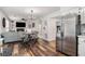 Open living space with hardwood floors, cozy seating, and stainless steel refrigerator at 3813 Battleview Ct, North Charleston, SC 29420