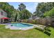 Beautiful backyard pool with lounge chairs and a view of the fenced yard at 3813 Battleview Ct, North Charleston, SC 29420