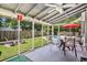 Screened porch with outdoor seating, overlooking a pool, lawn and fenced yard at 3813 Battleview Ct, North Charleston, SC 29420