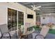 Enclosed porch area featuring an outdoor dining set, ceiling fan, and view of backyard at 3813 Battleview Ct, North Charleston, SC 29420