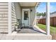 Inviting front porch with a chair and stylish front door at 383 Oak Park St, Summerville, SC 29486