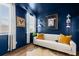 Comfortable office space with blue walls, hardwood floors, and a stylish white sofa at 383 Oak Park St, Summerville, SC 29486