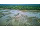 Aerial view of waterfront with long piers extending into the marshland at 392 Tombee Ct, Mount Pleasant, SC 29464