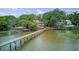 An aerial view of a long pier extending into the marshland near waterfront homes at 392 Tombee Ct, Mount Pleasant, SC 29464