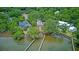 Aerial view of waterfront homes with private docks nestled among mature trees at 392 Tombee Ct, Mount Pleasant, SC 29464