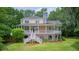 Charming back exterior with a full porch, brick foundation, and manicured lawn at 392 Tombee Ct, Mount Pleasant, SC 29464