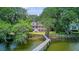 Stunning backyard view with a pier, lush landscaping, and a beautiful two-story home at 392 Tombee Ct, Mount Pleasant, SC 29464