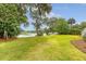 Lush backyard with mature trees, green lawn, and waterfront access, ideal for outdoor enjoyment at 392 Tombee Ct, Mount Pleasant, SC 29464