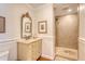 Elegant bathroom featuring a marble vanity, ornate mirror, and walk-in shower with neutral tile at 392 Tombee Ct, Mount Pleasant, SC 29464