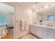Bathroom featuring double sink vanity with a large mirror and decorative wall accents at 392 Tombee Ct, Mount Pleasant, SC 29464