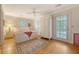 Bedroom with white walls, wood floors, ceiling fan, and access to an outdoor porch at 392 Tombee Ct, Mount Pleasant, SC 29464