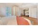 Bright bedroom featuring hardwood floors, white shuttered windows, and built in storage at 392 Tombee Ct, Mount Pleasant, SC 29464