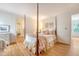 Bedroom with a four-poster bed, hardwood floors, and floral accents at 392 Tombee Ct, Mount Pleasant, SC 29464