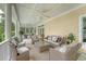 Inviting covered porch with comfortable seating, ceiling fans, and a peaceful ambiance for outdoor relaxation at 392 Tombee Ct, Mount Pleasant, SC 29464