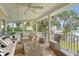 Relaxing covered porch with comfortable wicker seating, ceiling fan, and views of the river at 392 Tombee Ct, Mount Pleasant, SC 29464