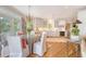 Open dining and kitchen area with chandelier and hardwood flooring at 392 Tombee Ct, Mount Pleasant, SC 29464