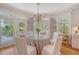 Charming dining area with chandelier and access to the outdoor balcony at 392 Tombee Ct, Mount Pleasant, SC 29464