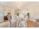 Elegant dining room with a round table, chandelier, and staircase view at 392 Tombee Ct, Mount Pleasant, SC 29464
