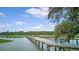 Scenic view of a long wooden dock extending into the water on a beautiful day at 392 Tombee Ct, Mount Pleasant, SC 29464