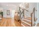 Grand entry with hardwood floors, staircase, and decorative plants in a bright, welcoming space at 392 Tombee Ct, Mount Pleasant, SC 29464