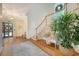Elegant foyer with a winding staircase, large window, and classic design elements at 392 Tombee Ct, Mount Pleasant, SC 29464