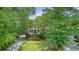 Beautiful two-story home with double balconies, surrounded by mature trees and lush landscaping at 392 Tombee Ct, Mount Pleasant, SC 29464