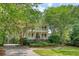 Charming two-story home with a double balcony, lush landscaping, and a curved driveway at 392 Tombee Ct, Mount Pleasant, SC 29464