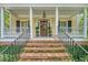 Inviting front porch with classic columns, black shutters, and a brick staircase leading to the front door at 392 Tombee Ct, Mount Pleasant, SC 29464