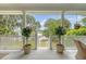 Inviting front porch featuring white columns and planters with lovely views of the water and surrounding landscape at 392 Tombee Ct, Mount Pleasant, SC 29464